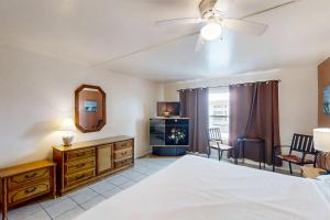 a bedroom with a bed and a ceiling fan at Gulfview I #312 in South Padre Island