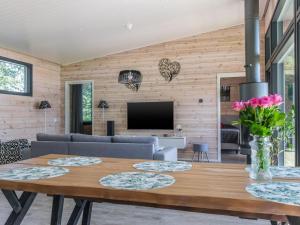 a dining room with a table and a tv at Holiday Home Villa aura by Interhome in Pälkäne