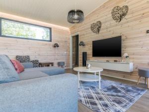 a living room with a couch and a tv at Holiday Home Villa aura by Interhome in Pälkäne