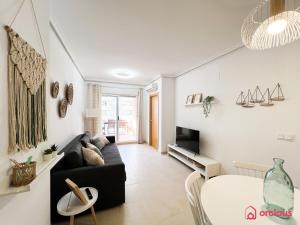a living room with a couch and a table at Marina Sunset 1era línea in Oropesa del Mar