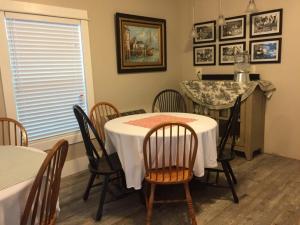 a dining room with a table and chairs and a kitchen at The Destination B&B llc in Salem