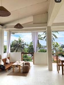 a living room with a view of the ocean at Ocean Bay Surf Resort Weligama in Weligama