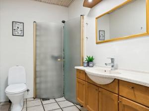 a bathroom with a shower and a sink and a toilet at Apartment Annica - 900m from the sea in NW Jutland by Interhome in Blokhus