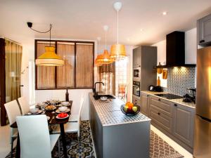 a kitchen with a table and a dining room at Apartment Vista del Arenal by Interhome in Jávea