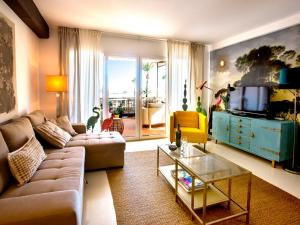a living room with a couch and a tv at Apartment Vista del Arenal by Interhome in Jávea