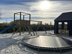 un parque infantil en la arena con un tobogán en Holiday Home Grep - 800m from the sea in NE Jutland by Interhome, en Strandby