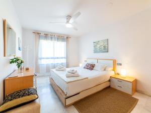 a bedroom with a large bed and a window at Apartment Dioniso - Playa Romanilla by Interhome in Roquetas de Mar
