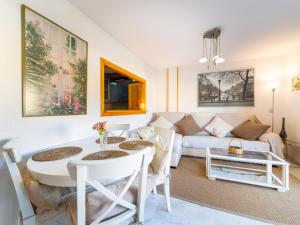 a living room with a couch and a table at Apartment Dioniso - Playa Romanilla by Interhome in Roquetas de Mar