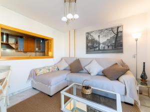 a living room with a couch and a table at Apartment Dioniso - Playa Romanilla by Interhome in Roquetas de Mar +13 photos