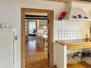 a kitchen with a counter and a dining room at Holiday Home Maelle - 25km from the sea in Western Jutland by Interhome in Højer