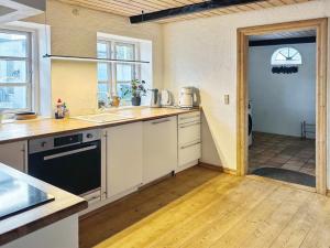 a kitchen with a sink and a stove top oven at Holiday Home Maelle - 25km from the sea in Western Jutland by Interhome in Højer