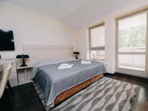 a bedroom with a bed with two towels on it at Studio Harrachov Resident by Interhome in Harrachov
