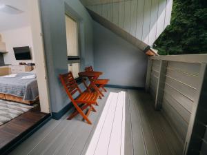a room with two chairs and a table and a bed at Studio Harrachov Resident by Interhome in Harrachov
