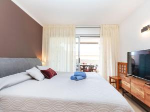 une chambre avec un grand lit et une télévision dans l'établissement Apartment Les Suredes-3 by Interhome, à Sant Antoni de Calonge