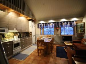 a kitchen with a table and chairs in it at Holiday Home Tunturikoivu b1 by Interhome in Saariselka