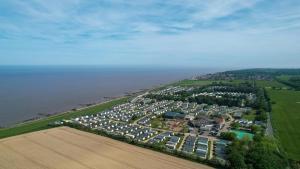 an aerial view of a parking lot next to the ocean at Spacious Caravan On The Suffolk Coast With Outside Decking Too Ref 20044bs in Hopton on Sea