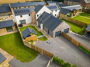 an aerial view of a house with solar panels on it at Northumberland Luxury Stays - The Newland in West Chevington