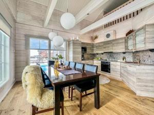 a kitchen with a dining table and a large animal chair at Holiday Home Kontiokota by Interhome in Saariselka