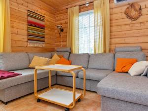a living room with a couch and a table at Holiday Home Velho 2 by Interhome in Saariselka