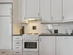 a kitchen with white appliances and white cabinets at Holiday Home Velho 2 by Interhome in Saariselka +11 photos