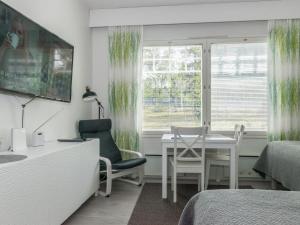 a bedroom with a desk and a table and chairs at Holiday Home Rautulampi h 23 by Interhome in Saariselka