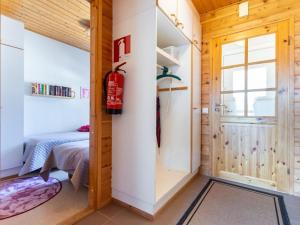 a bedroom with a door leading to a bed at Holiday Home Urupää c 13 by Interhome in Saariselka +5 photos