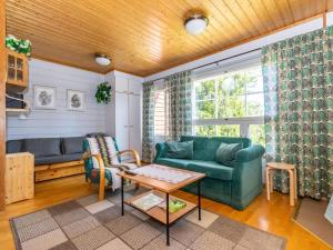 a living room with a couch and a table at Holiday Home Urupää c 13 by Interhome in Saariselka