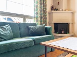 a living room with a green couch and a table at Holiday Home Urupää c 13 by Interhome in Saariselka