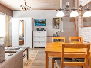 a dining room and living room with a table and chairs at Holiday Home Siularinne b 8 by Interhome in Saariselka
