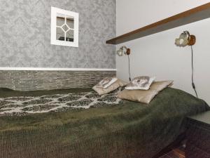 a bedroom with a bed with two pillows on it at Holiday Home Siularinne b 8 by Interhome in Saariselka