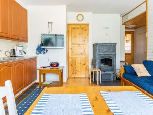 a living room with a blue couch and a fireplace at Holiday Home Outapailakka j 10 by Interhome in Saariselka