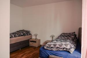 a bedroom with two beds and a night stand at Ostertor 2 in Sarstedt