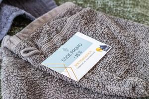 a card sitting on top of a sweater at Appart'Hotel NuiteeJour Versailles Saint Cyr l'Ecole in Saint-Cyr-lʼÉcole +114 photos