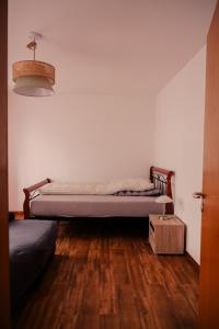 a bedroom with two beds and a wooden floor at Ostertor 2 in Sarstedt