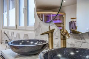 a bathroom with a sink and a bowl on a counter at L'Evasion - Sauna Jacuzzi Cinema in Tours