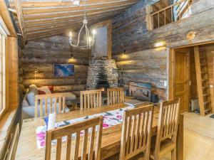 a dining room with a table and chairs and a fireplace at Holiday Home Talles by Interhome in Saariselka