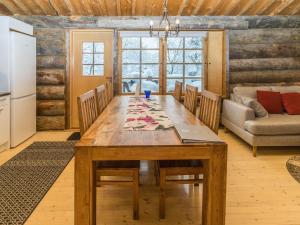a kitchen and dining room with a wooden table at Holiday Home Talles by Interhome in Saariselka
