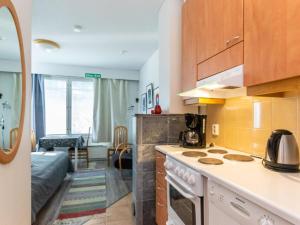 a kitchen with a stove top oven next to a living room at Holiday Home Rautulampi g 20 by Interhome in Saariselka