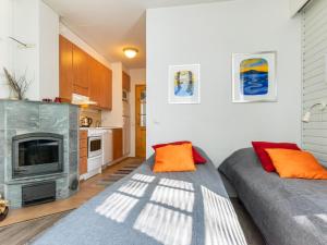 a living room with two beds and a fireplace at Holiday Home Rautulampi g 20 by Interhome in Saariselka