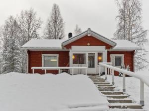 a house covered in snow in the snow at Holiday Home Käpälämäki by Interhome in Raanujärvi