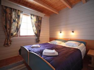 a bedroom with a bed with towels on it at Holiday Home Tunturikoivu a1 by Interhome in Saariselka