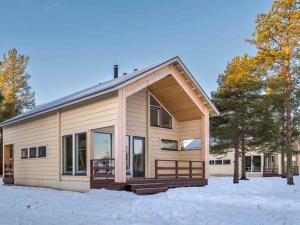 a small house in the snow next to trees at Holiday Home Siika by Interhome in Hailuoto