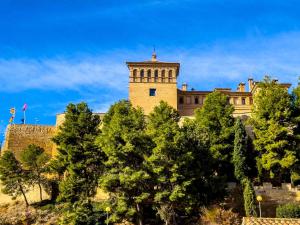 a building with a tower on top of trees at MEQUEDO CALDEREROS 25 in Alcañiz
