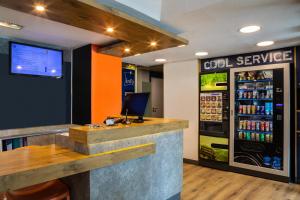 a bar in a restaurant with a soda cooler at ibis budget Marne la Vallée Chelles in Chelles