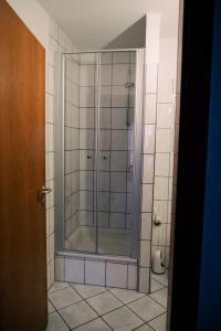 a shower with a glass door in a bathroom at Ostertor 2 in Sarstedt