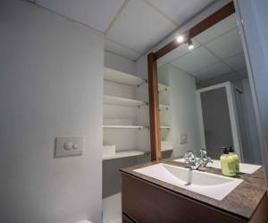 a bathroom with a sink and a mirror at MEQUEDO CALDEREROS 25 in Alcañiz +33 photos