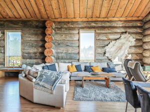 a living room with a couch in a log cabin at Holiday Home Uuvana by Interhome in Saariselka