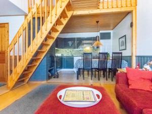 a living room with a red couch and a table at Holiday Home Teerenpesue e 38 by Interhome in Saariselka