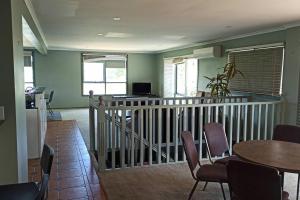 a living room with a table and chairs and a table and chairsktop at 6 Bedrooms 11 Beds with Spacious City Park Views and Beach in Frankston