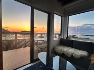 a living room with a couch and a view of the ocean at 海宿ニシノヤ 